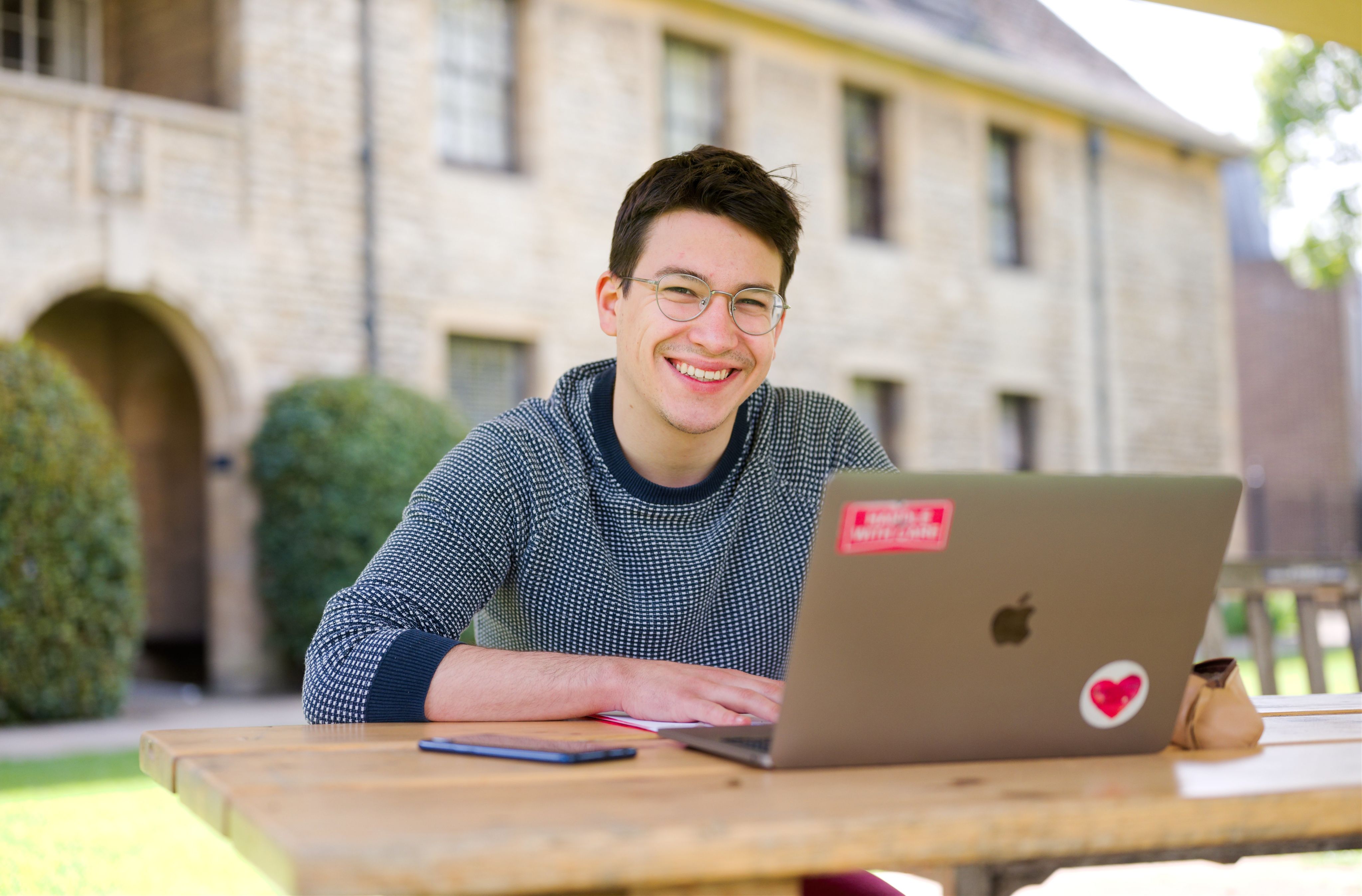 Student smiling with laptop