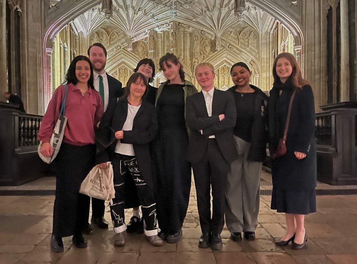 Iona and other students smiling with author Ali Smith