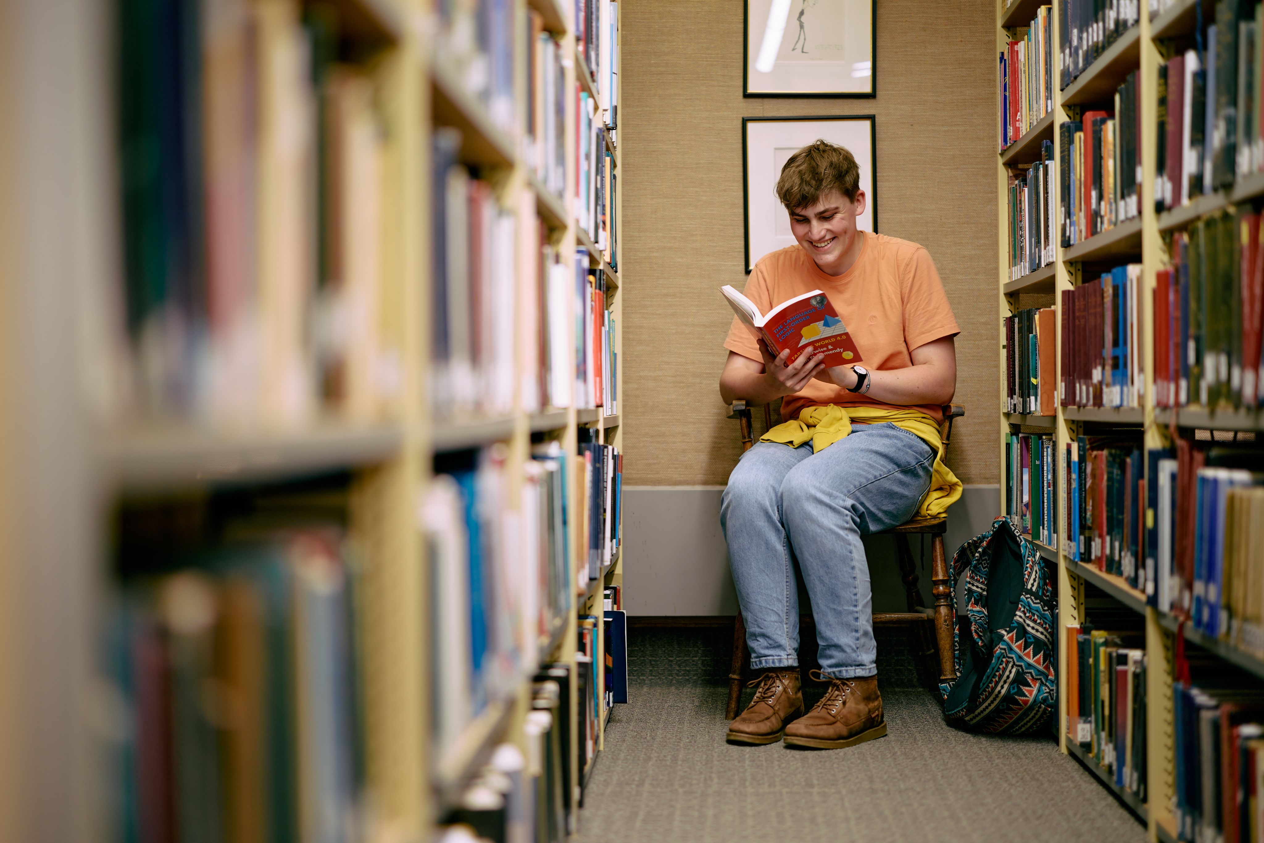 Male student reading in the library