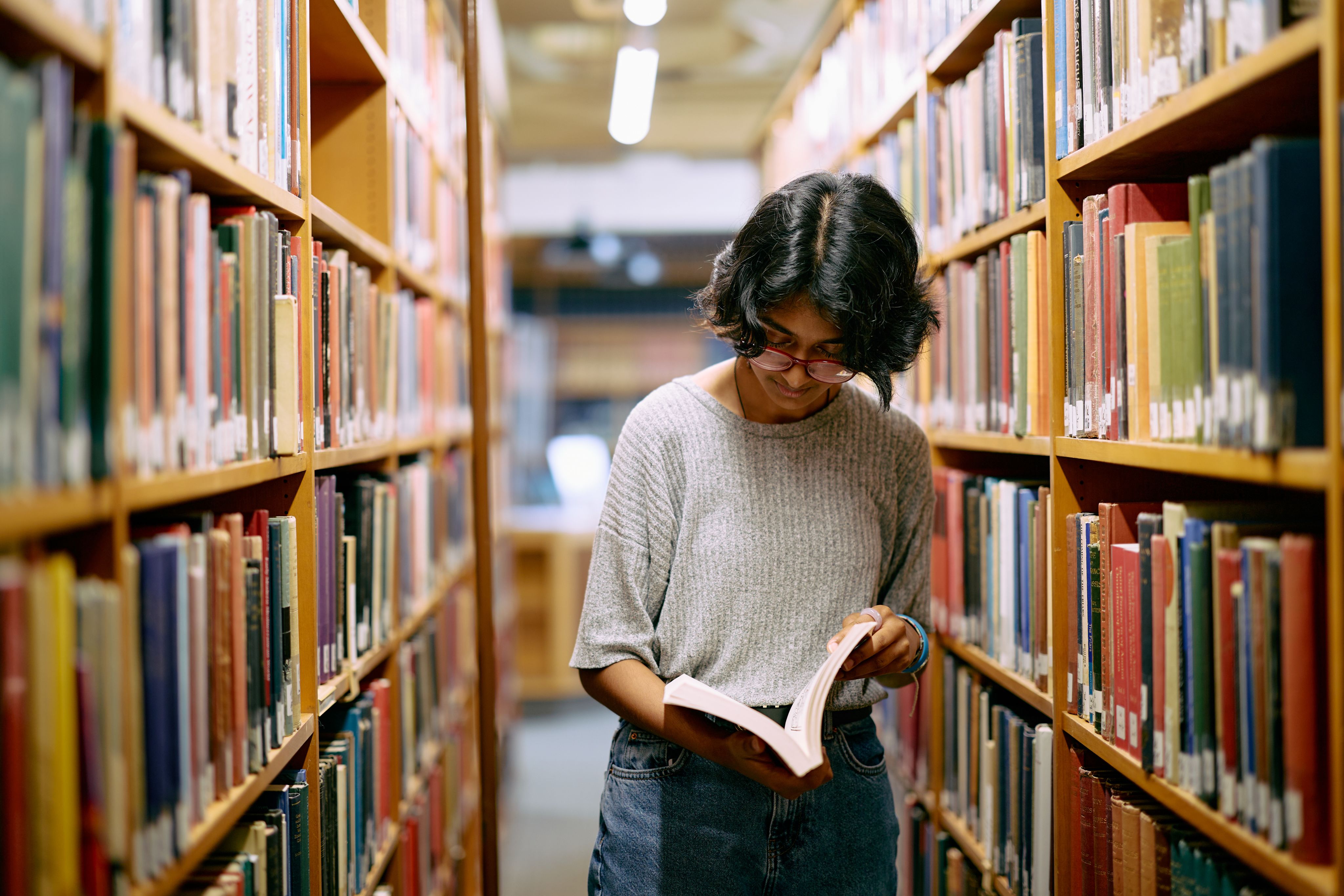 Student reading in library