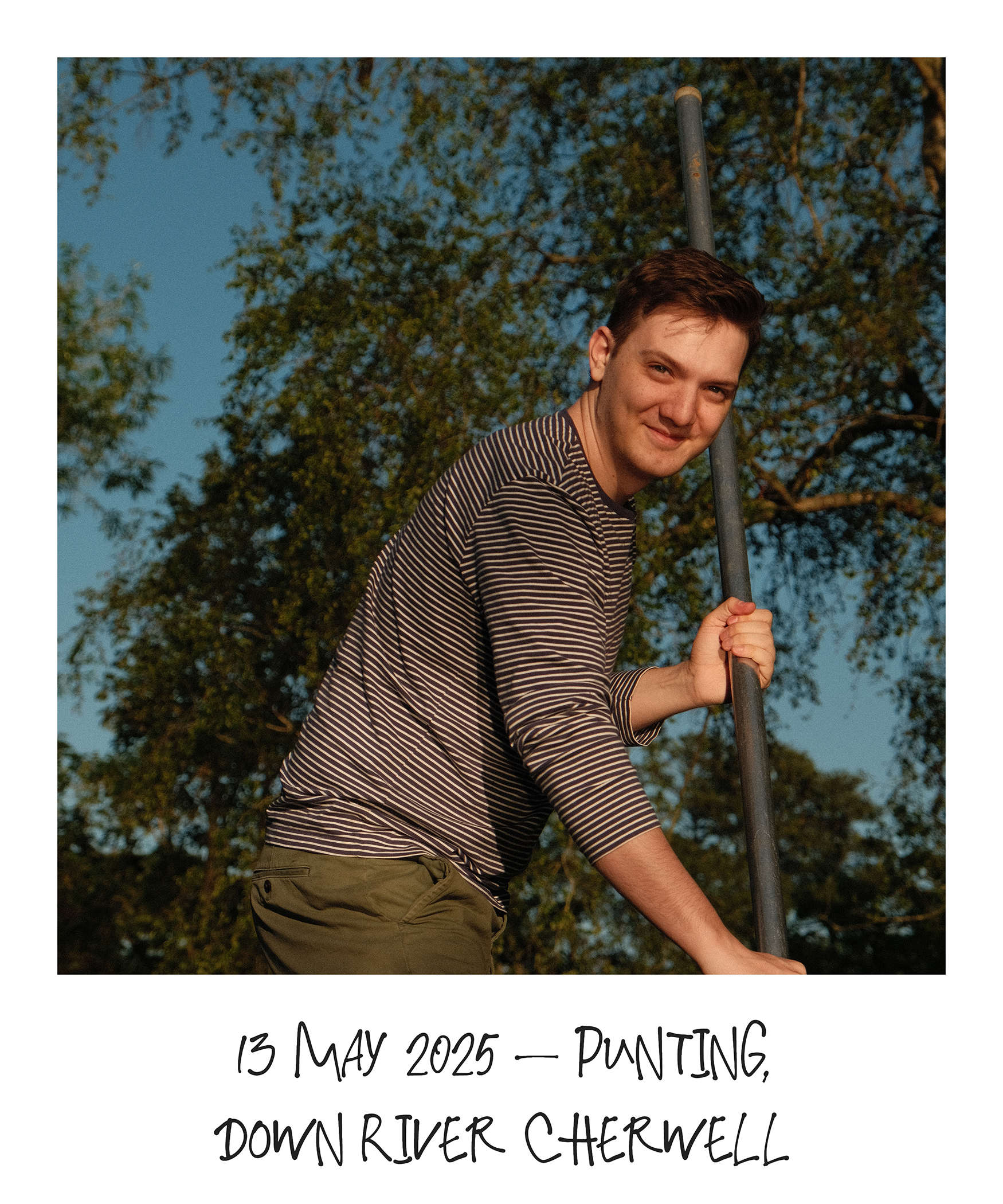 Male student smiling at camera while punting