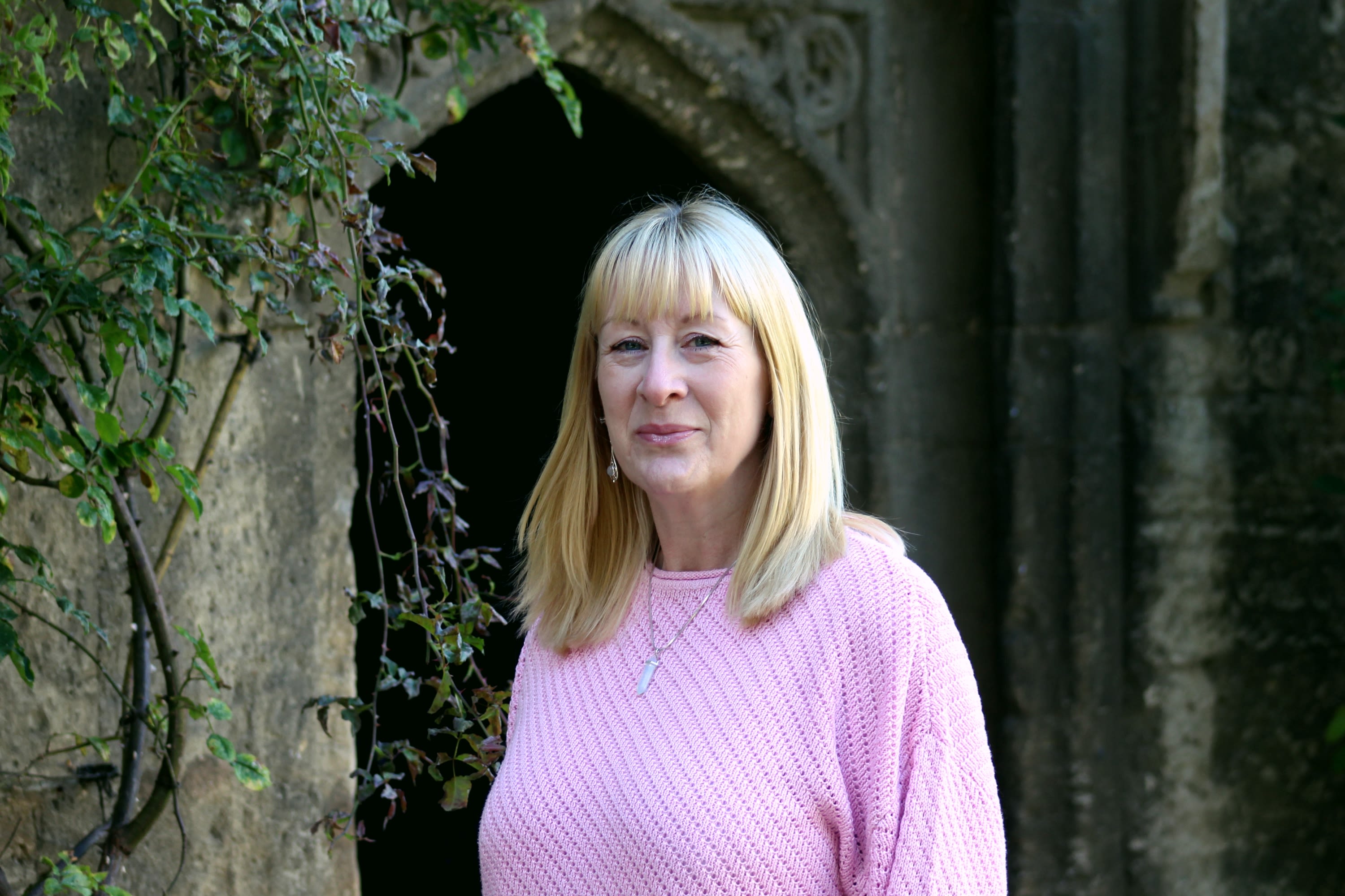 Blonde woman smiles at camera